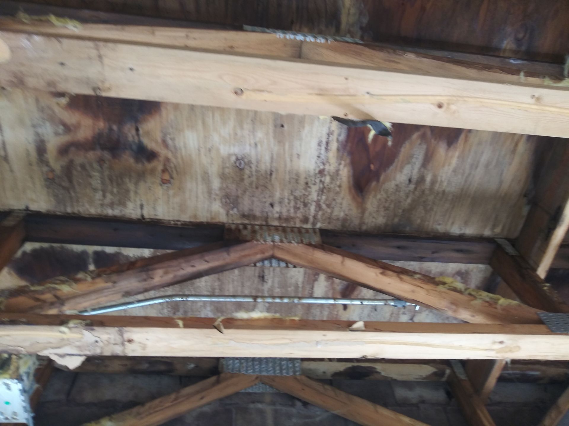 A wooden structure with a few wires hanging from it