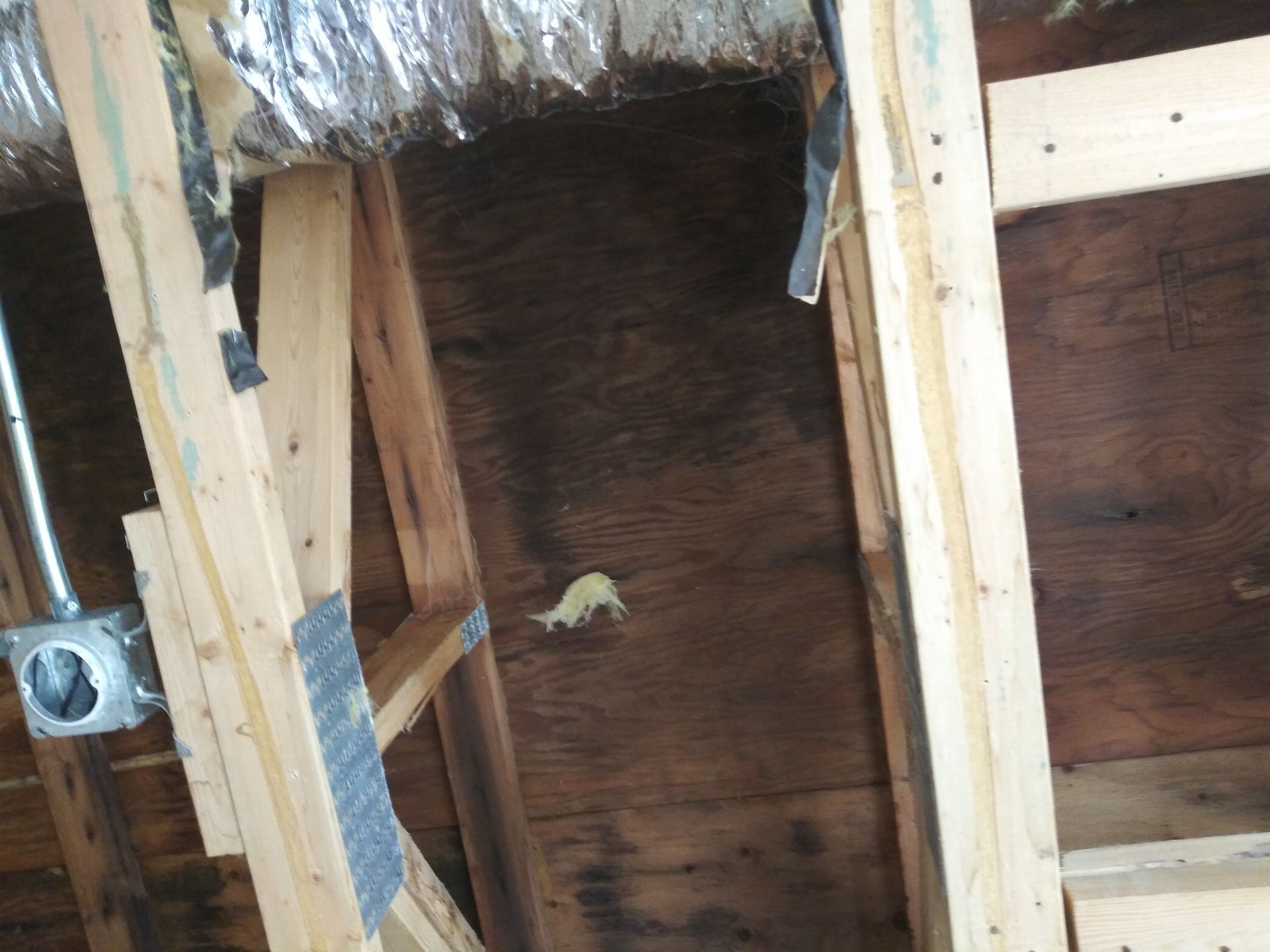 A wooden structure with a metal pipe coming out of it