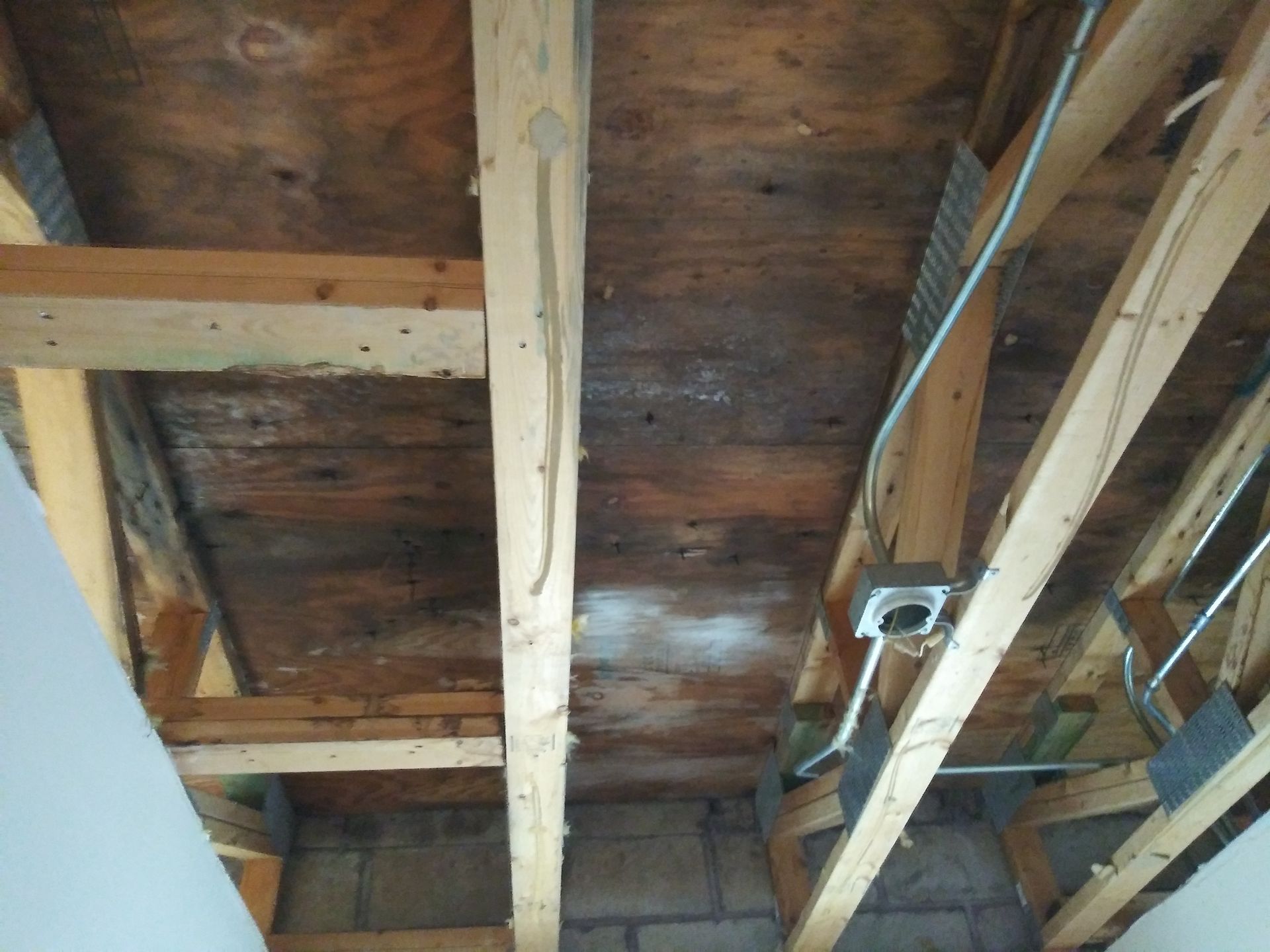 A wooden ceiling with wires hanging from it