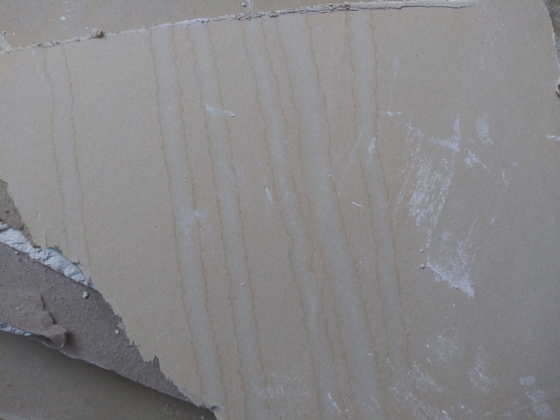 A close up of a piece of cardboard that looks like a piece of wood.