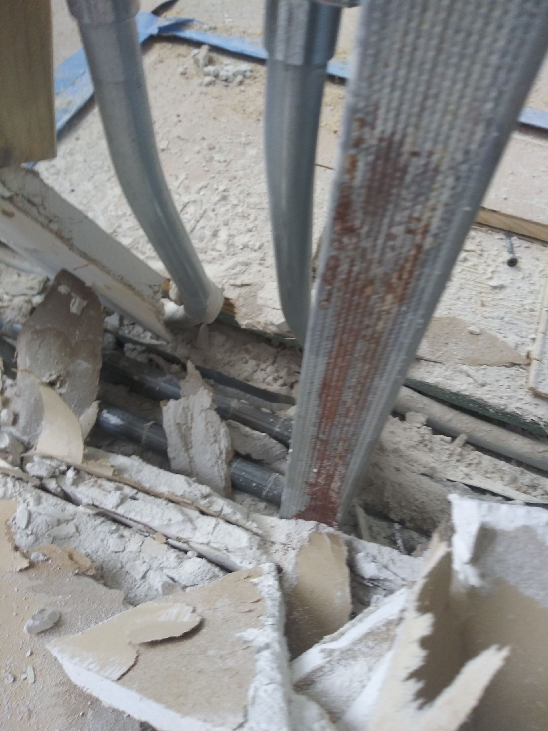 A broken piece of cardboard is laying on the ground