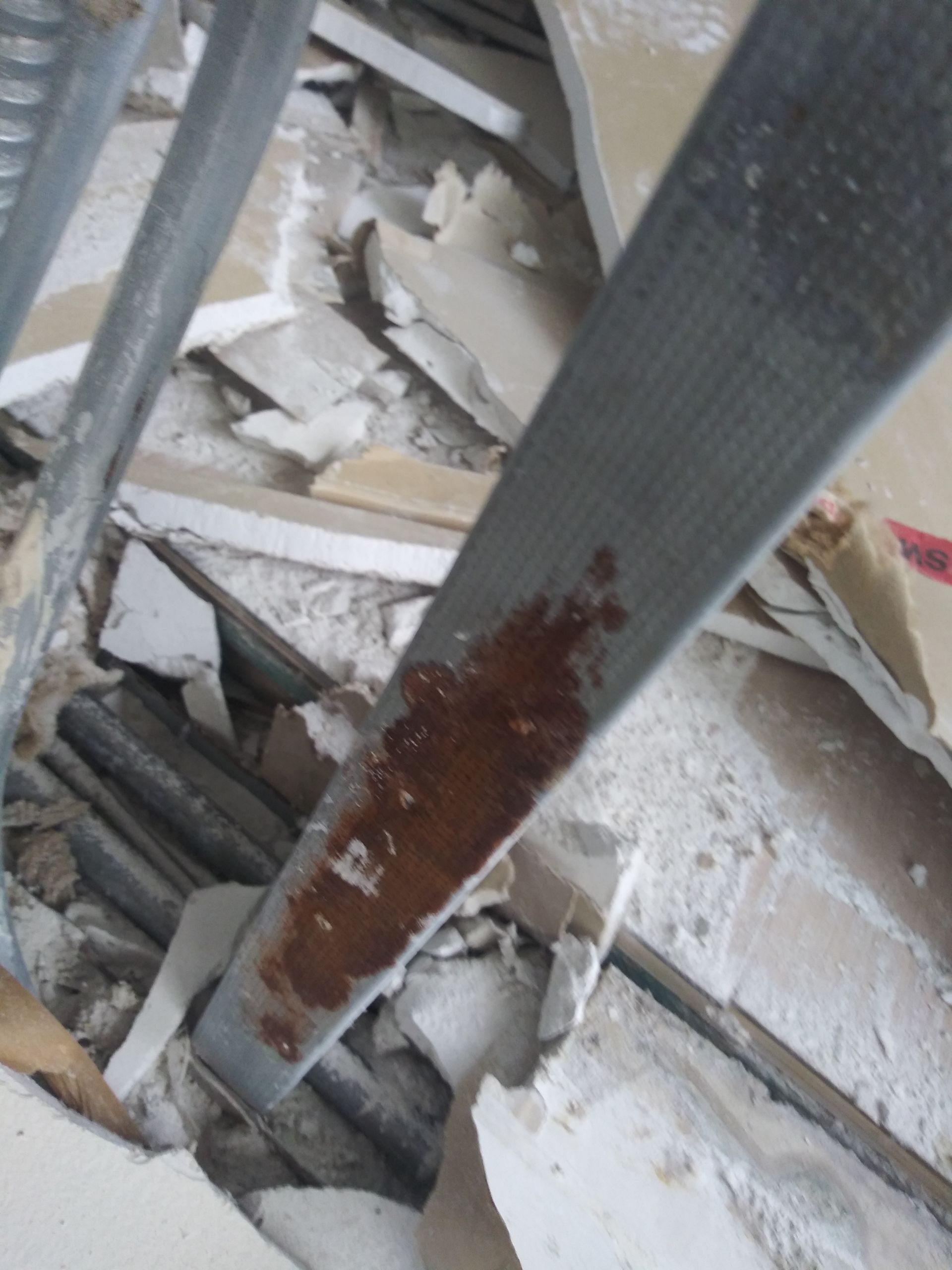 A pile of broken pieces of concrete and metal