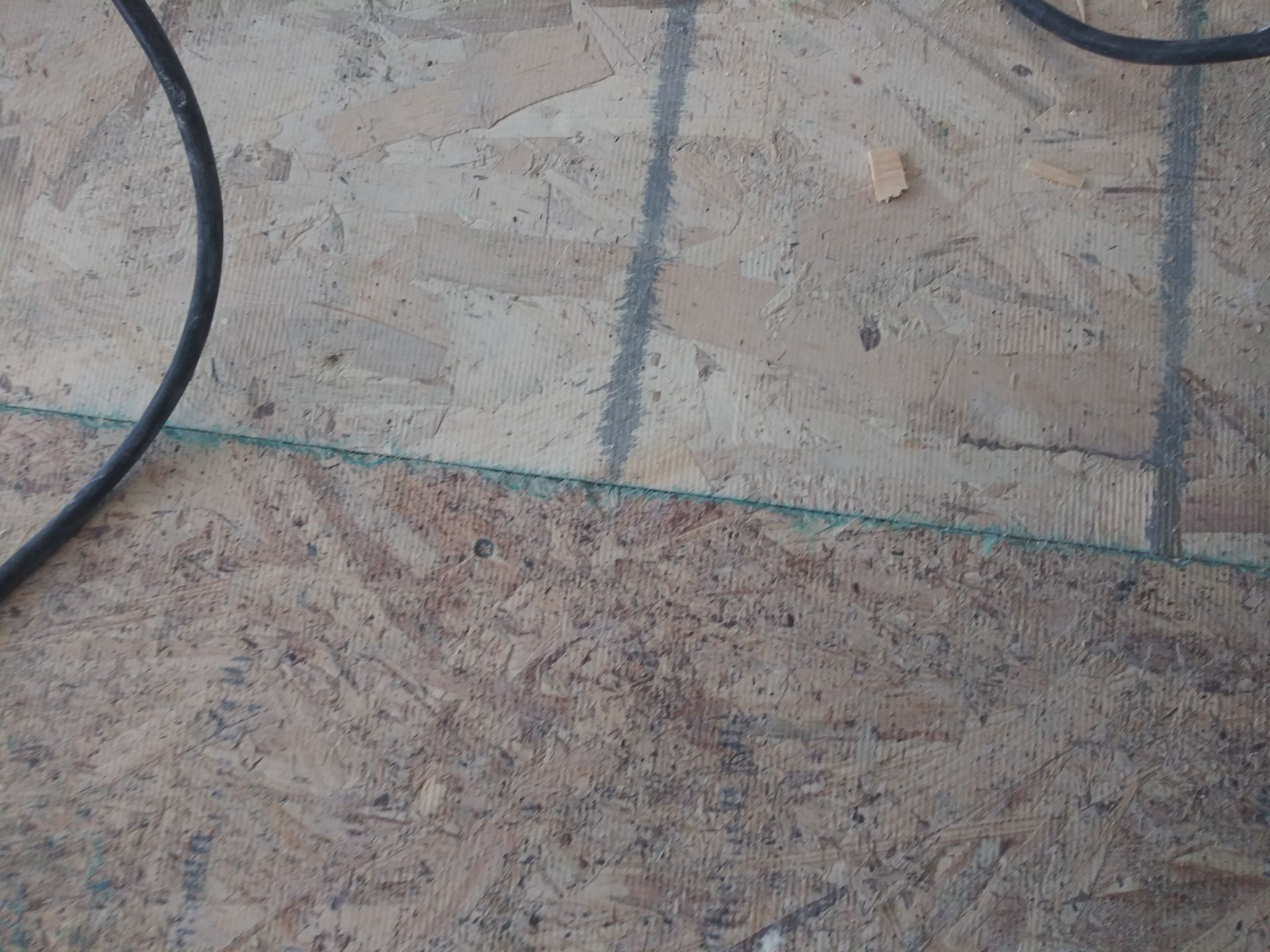 A close up of a wooden floor with a few wires on it