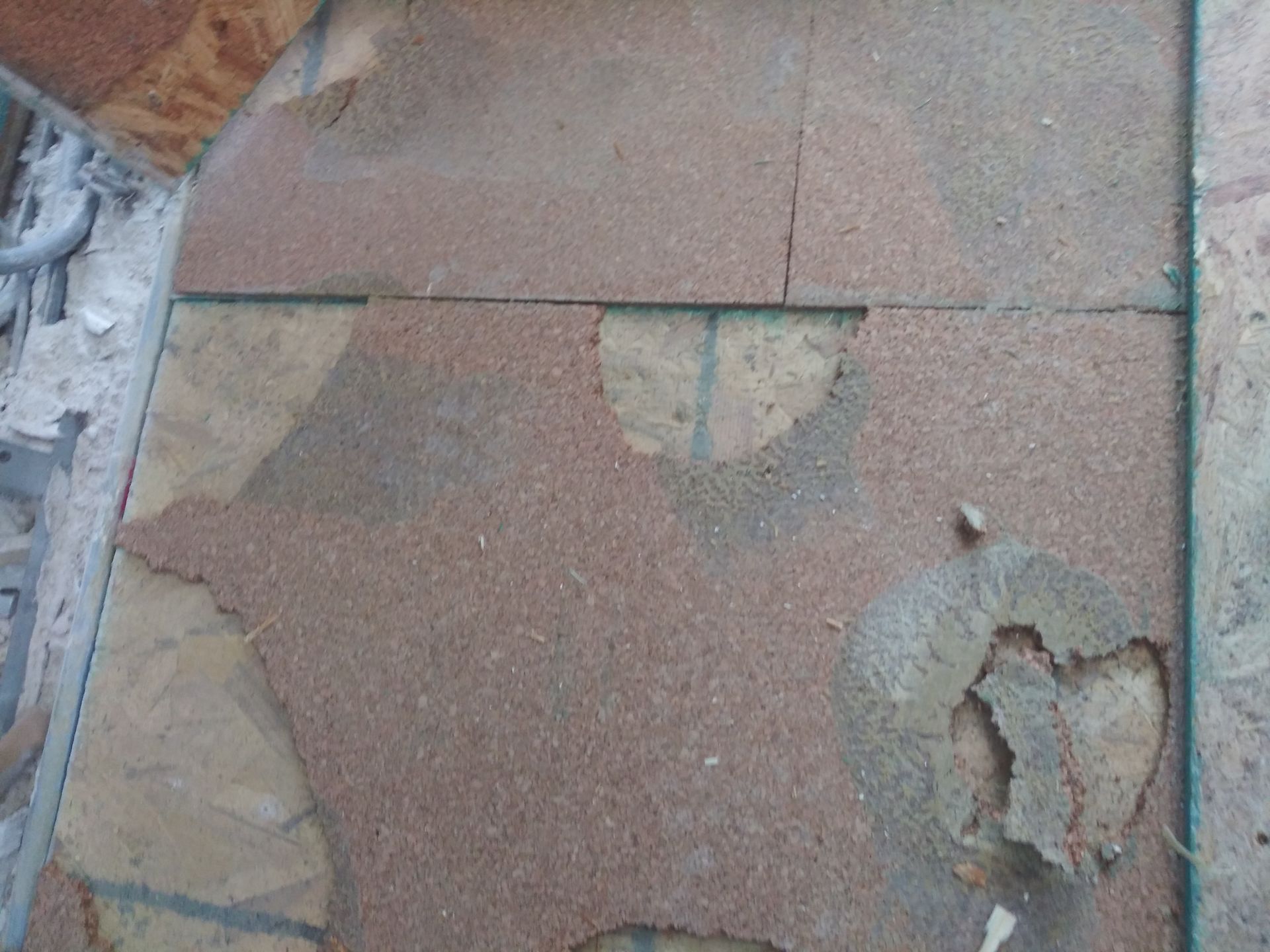 A close up of a tiled floor with a hole in it.