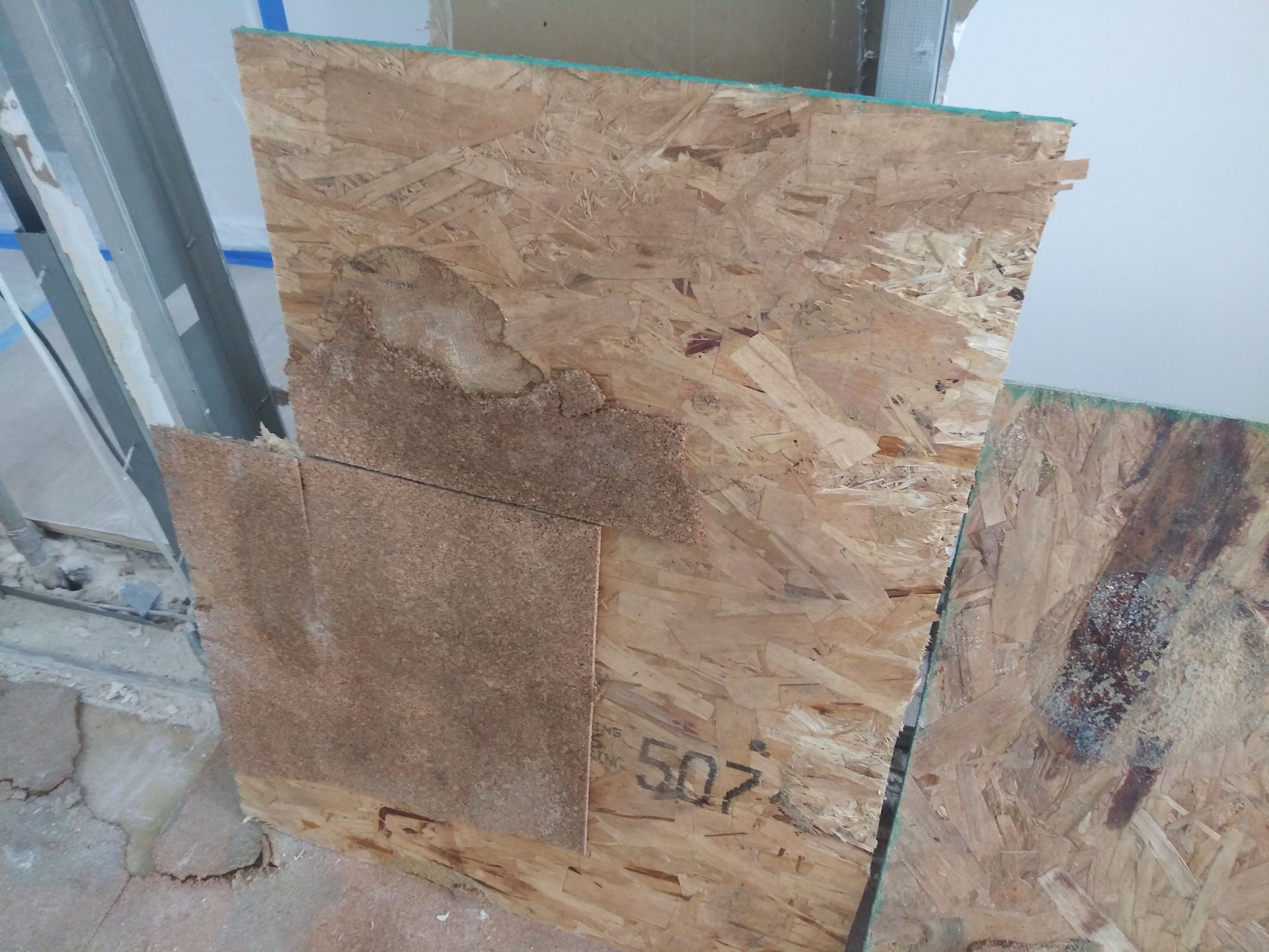 A piece of plywood with the number 507 on it.