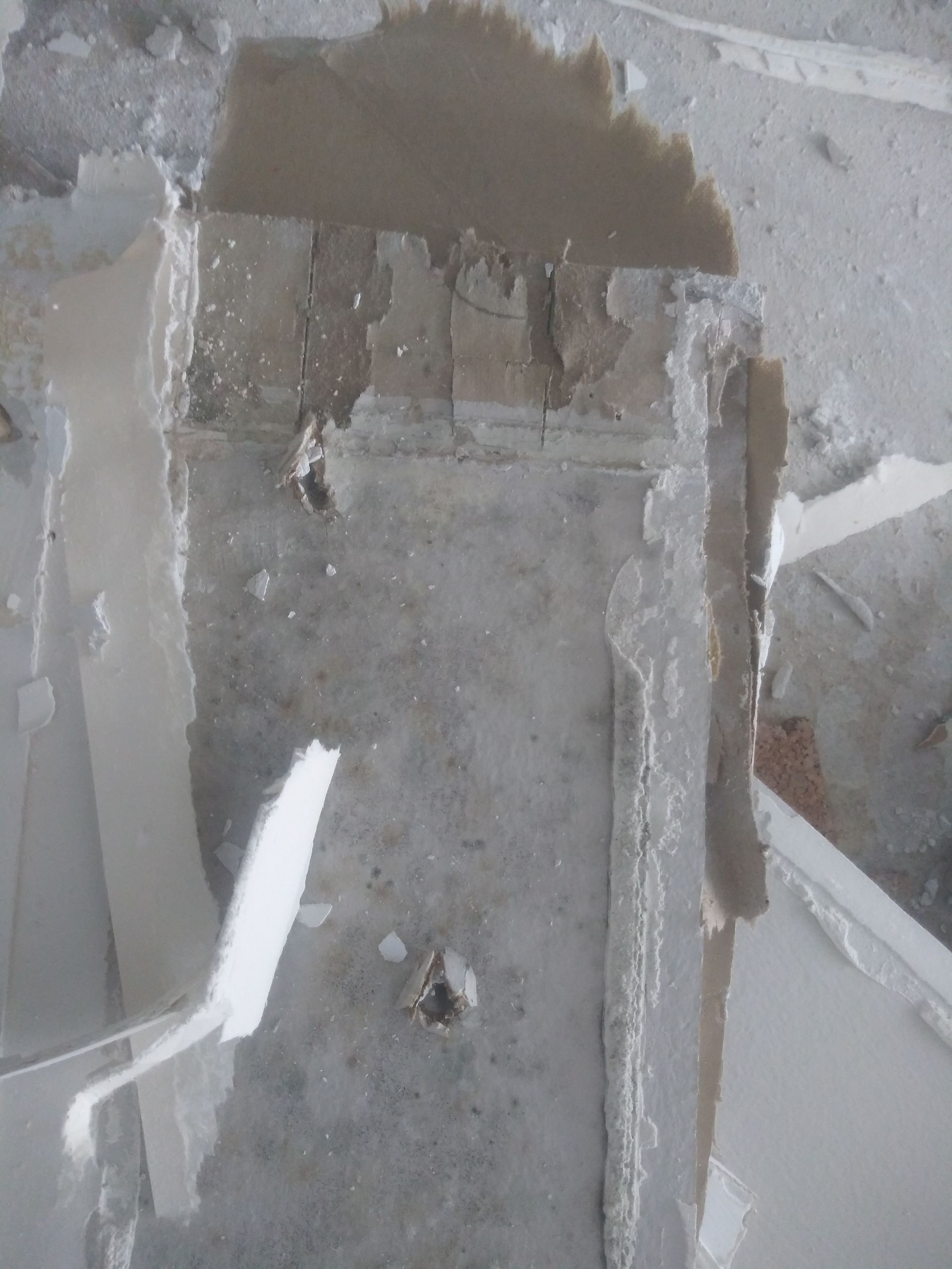 A close up of a concrete wall with a hole in it