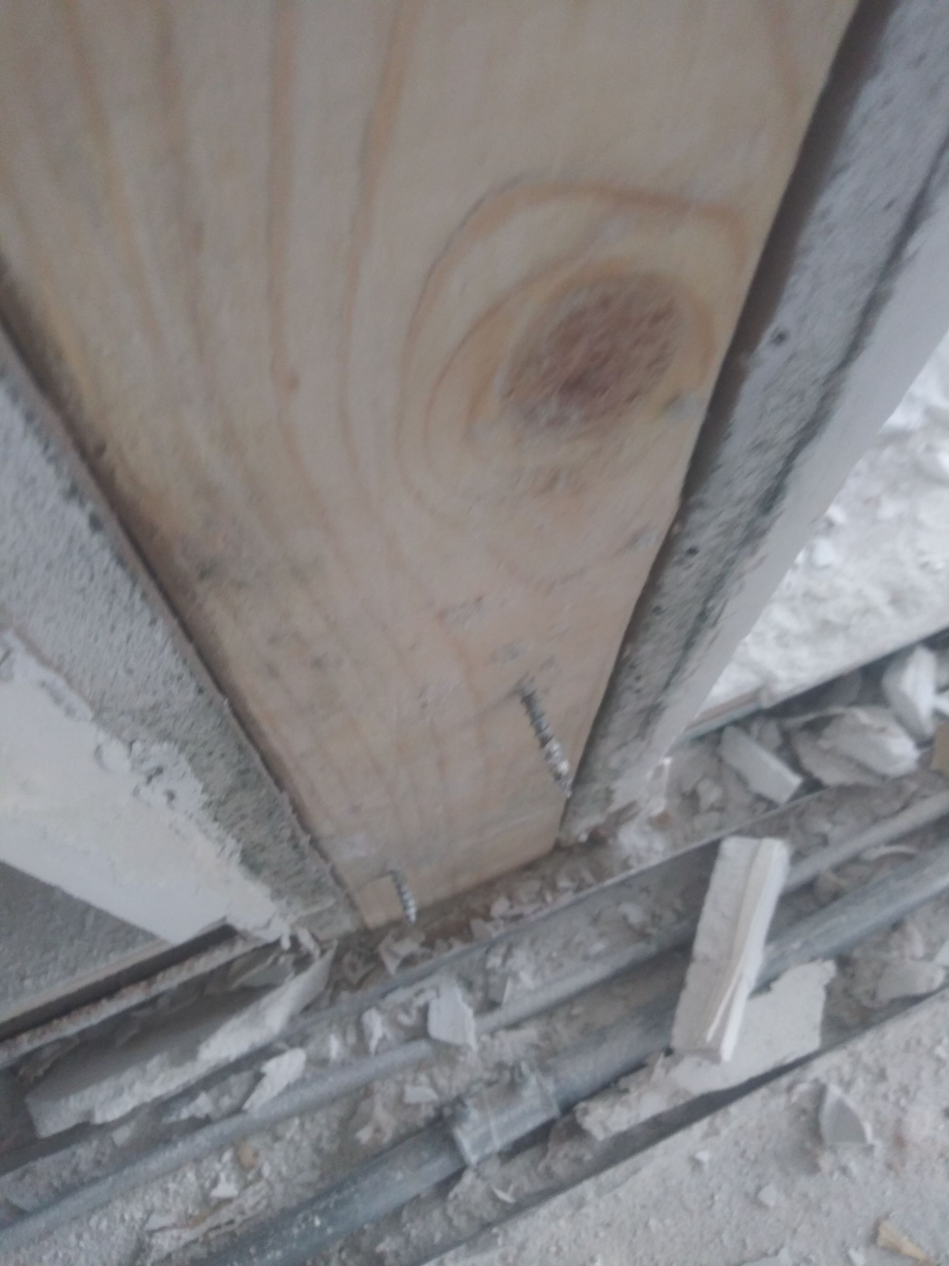 A close up of a piece of wood with a screw in it.