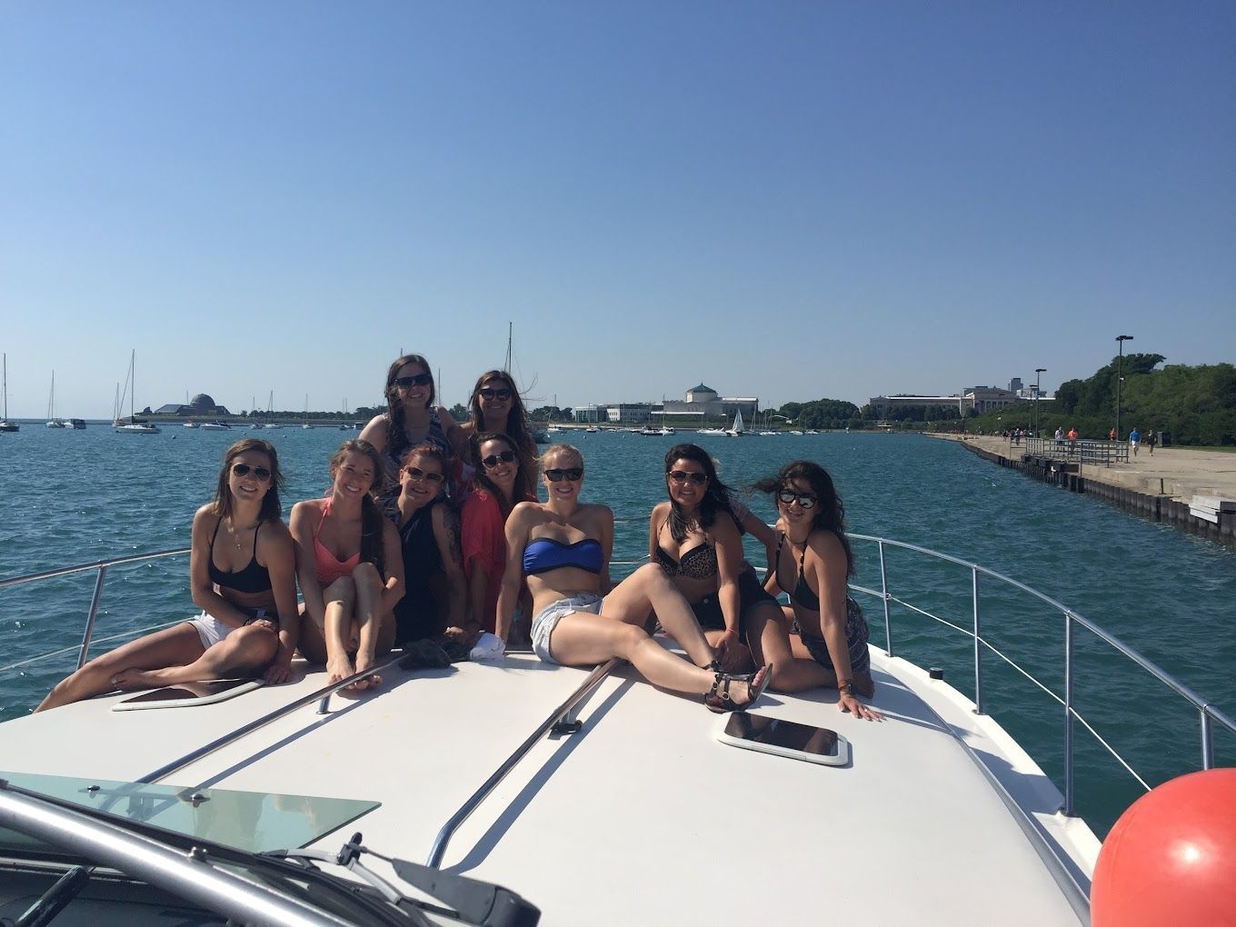 a group of women sitting on the back of a boat rental in Chicago