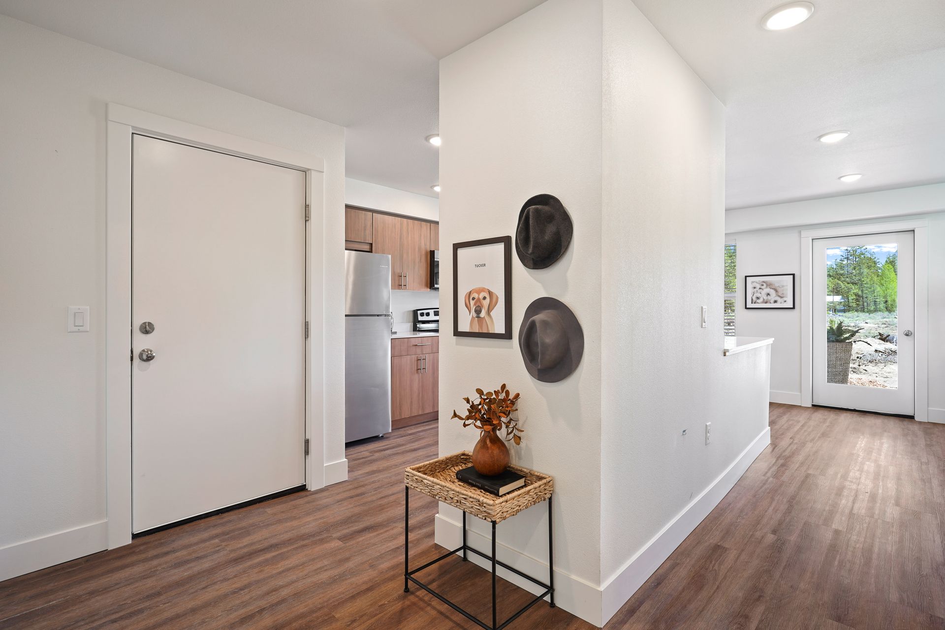 A hallway in a house with a table in the middle of it.