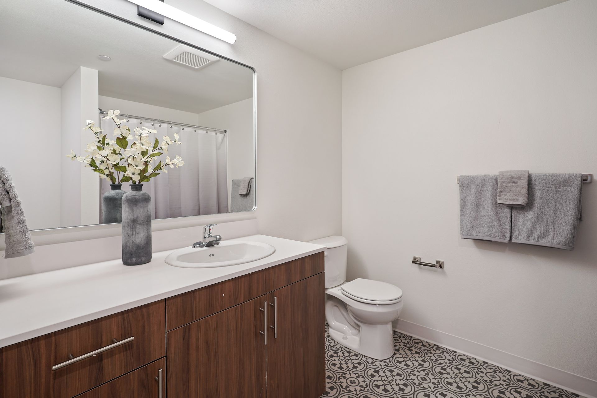 A bathroom with a sink , toilet , and mirror.