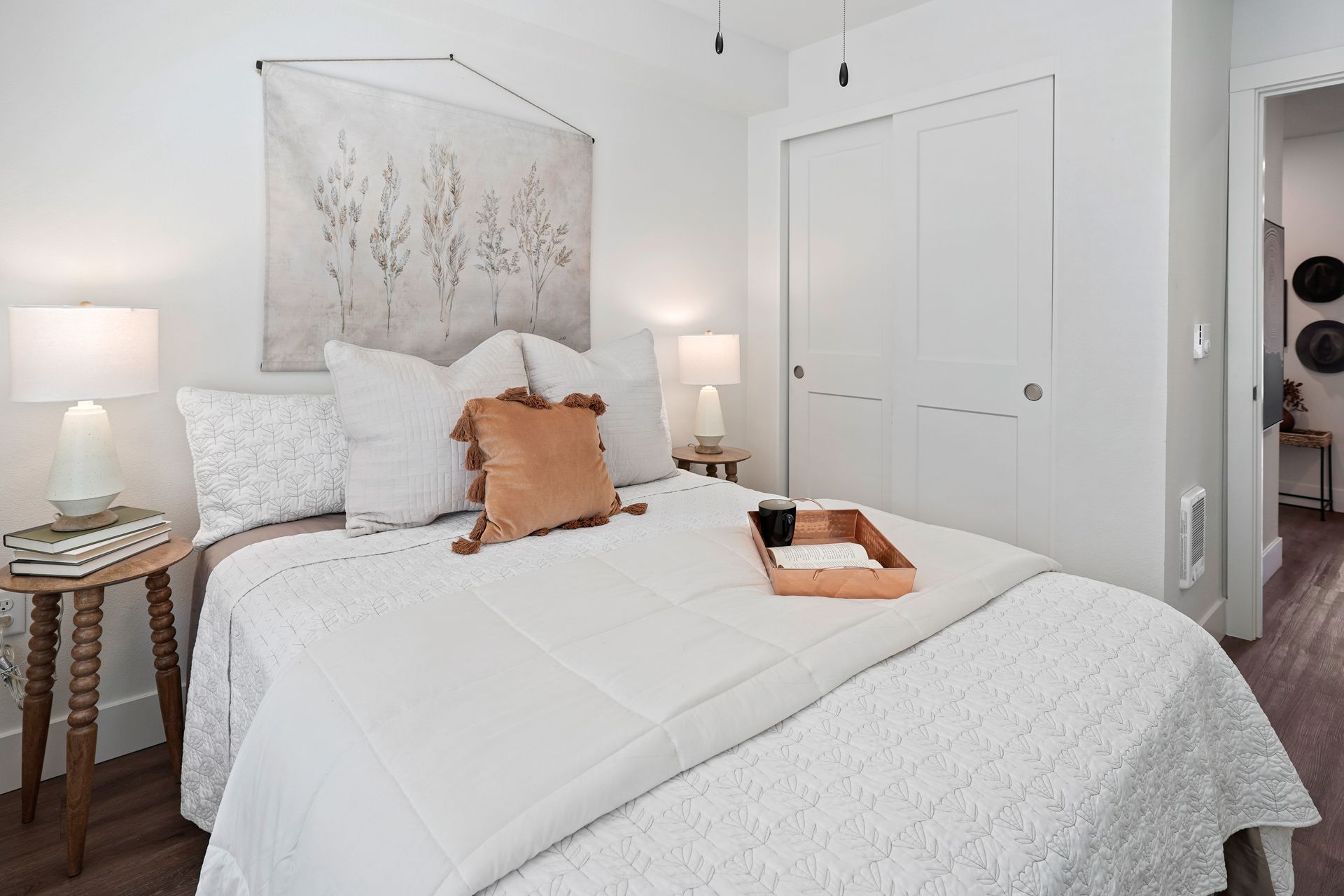 A bedroom with a bed and a tray on it.