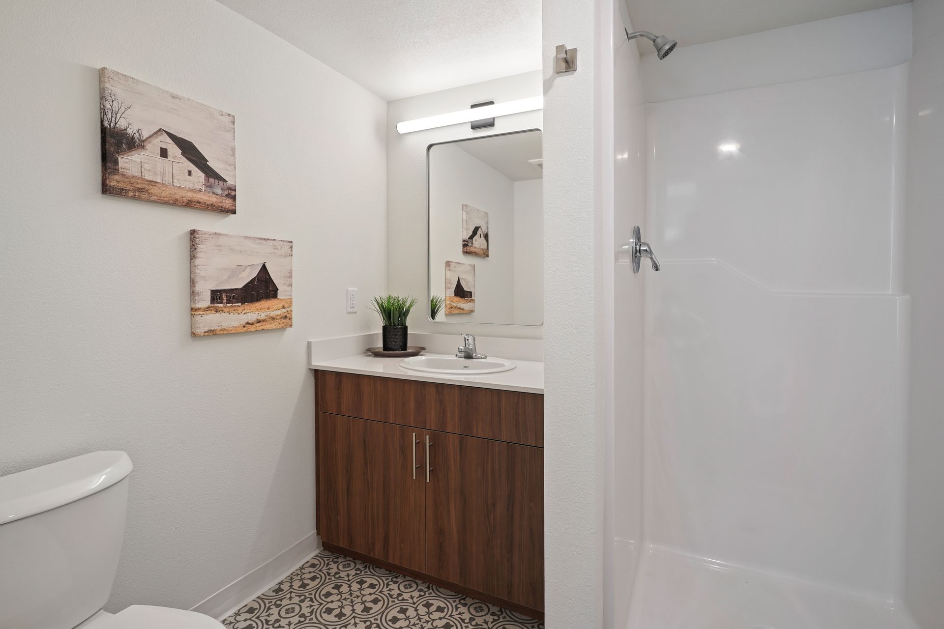 A bathroom with a toilet , sink , and shower.