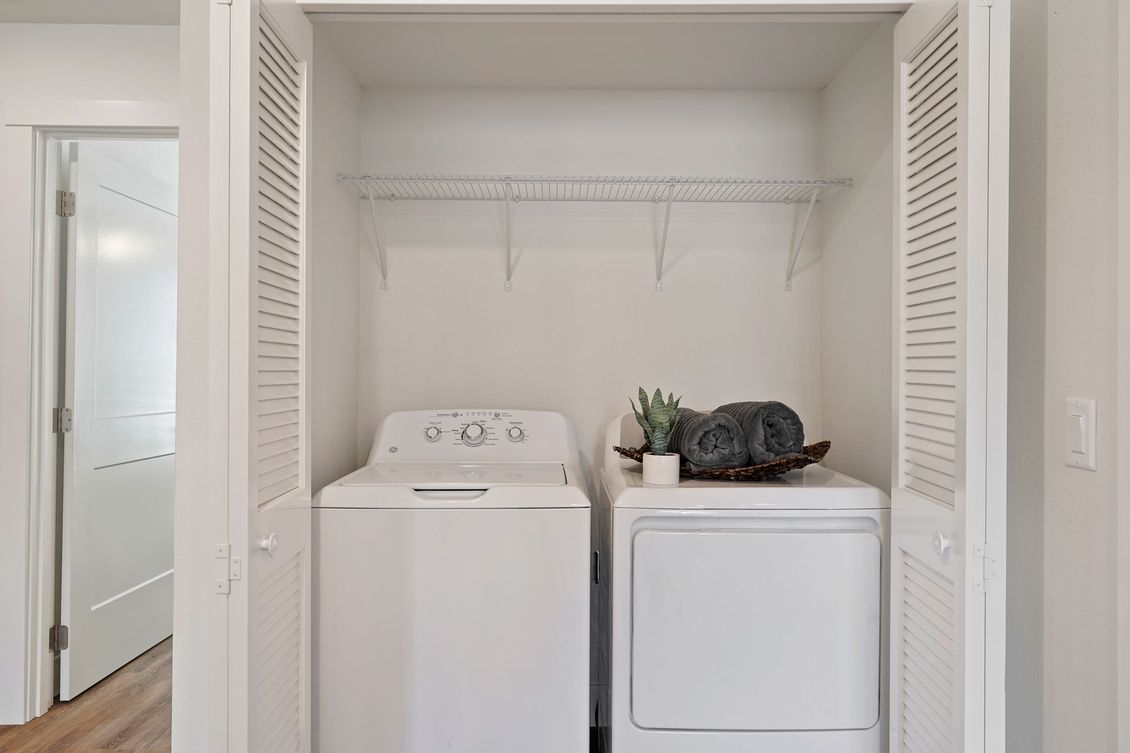 A laundry room with a washer and dryer in a closet.