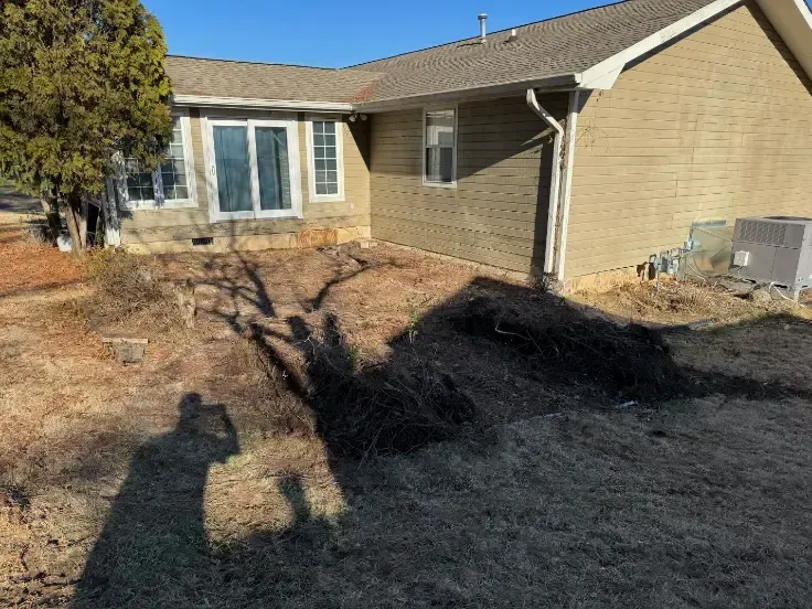 A house with a wooden deck and stairs in front of it after demolition