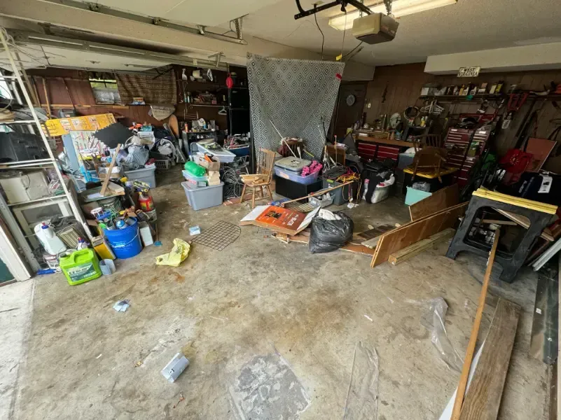 A garage filled with lots of junk and tools.