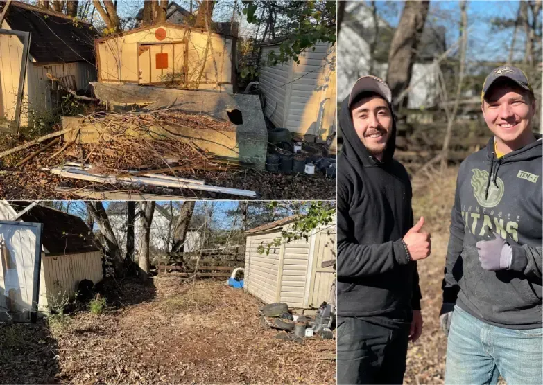 Two men are standing next to each other in front of a shed.