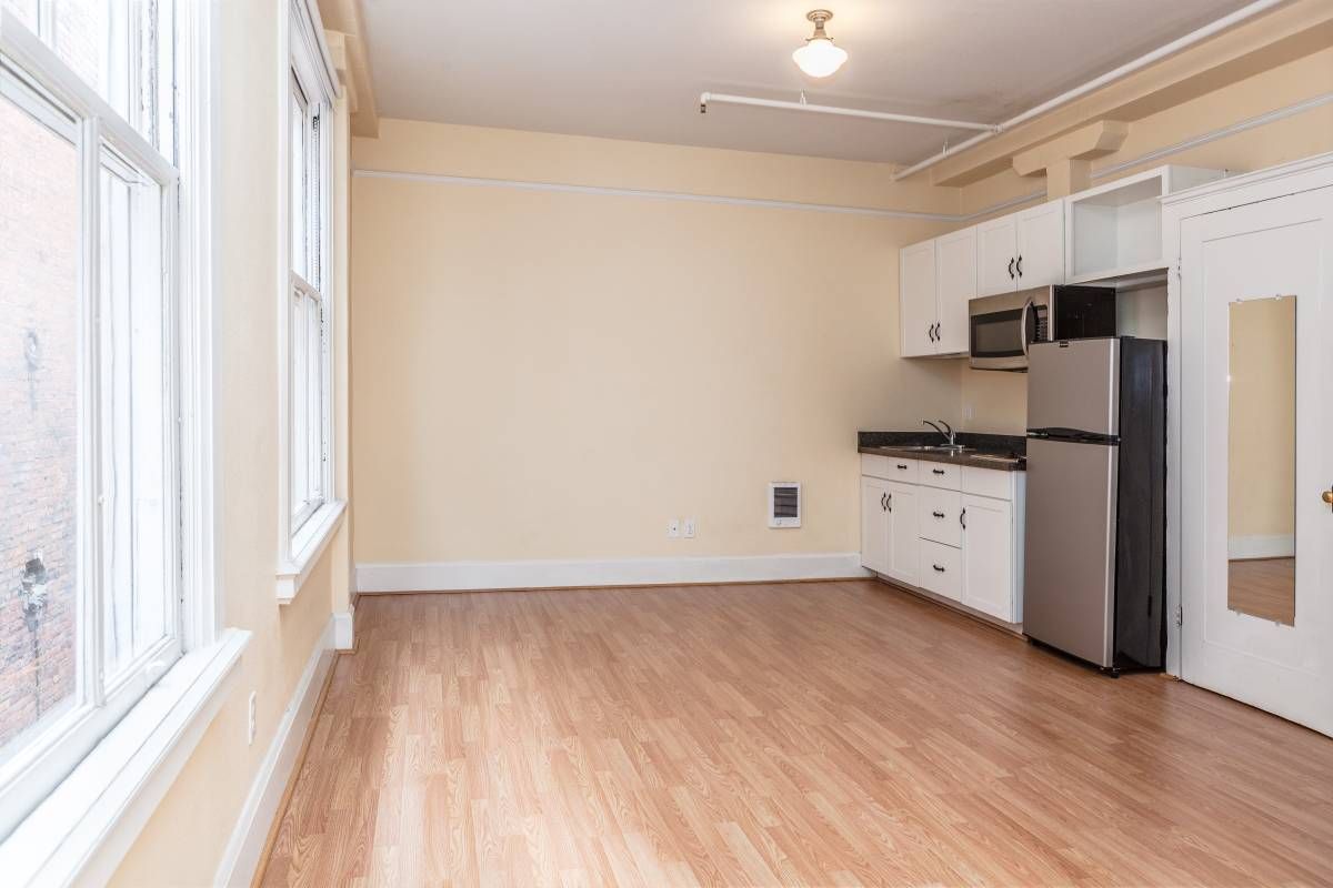 A kitchen with stainless steel appliances and hardwood floors