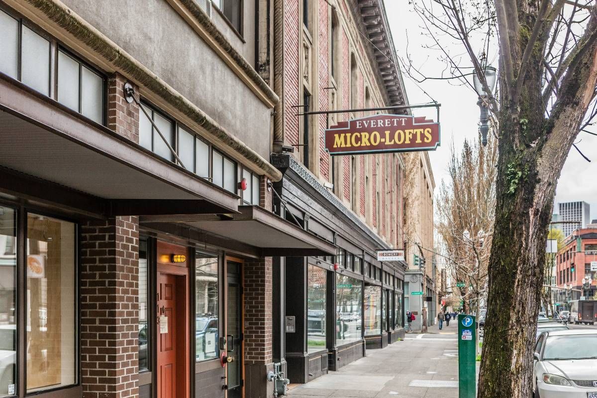 A brick building with a sign that says micro lofts on it.