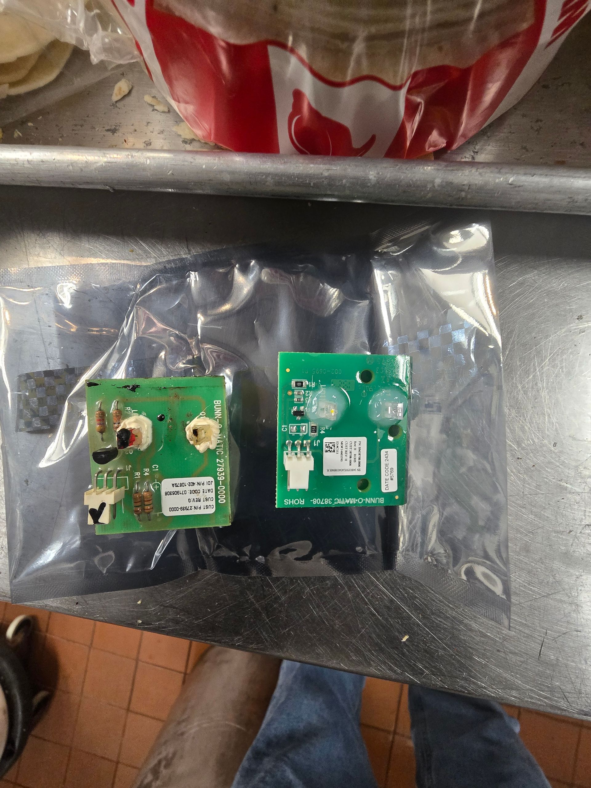 Two pieces of electronic equipment are sitting on a table.