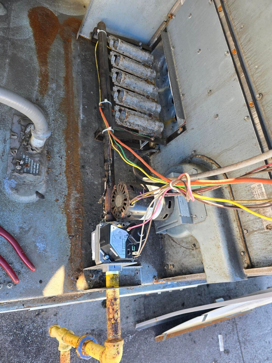 A stove with a lot of wires coming out of it.