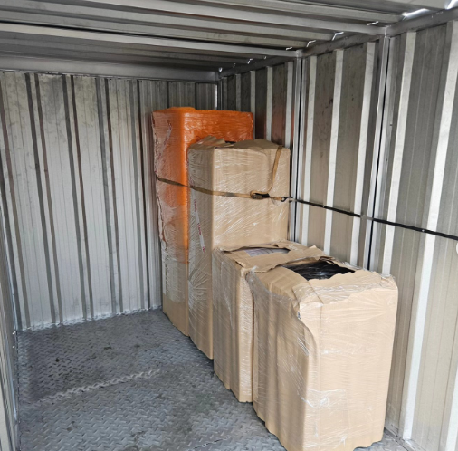 Camiones cargando y descargando cajas en un almacén.