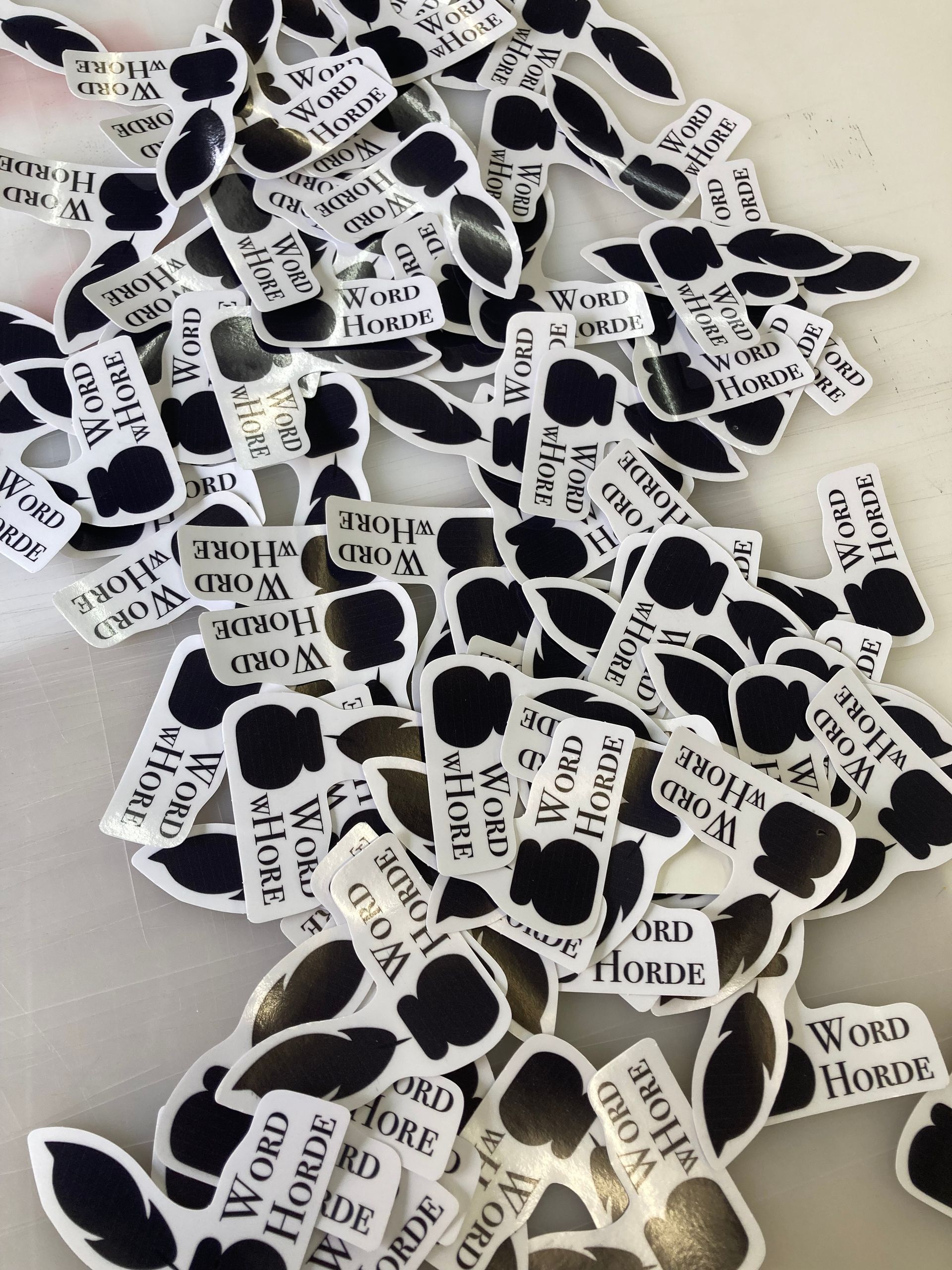 A pile of black and white stickers with the word home on them