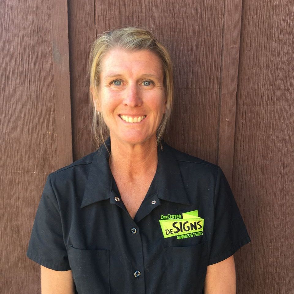 A woman wearing a black shirt with the word signs on it
