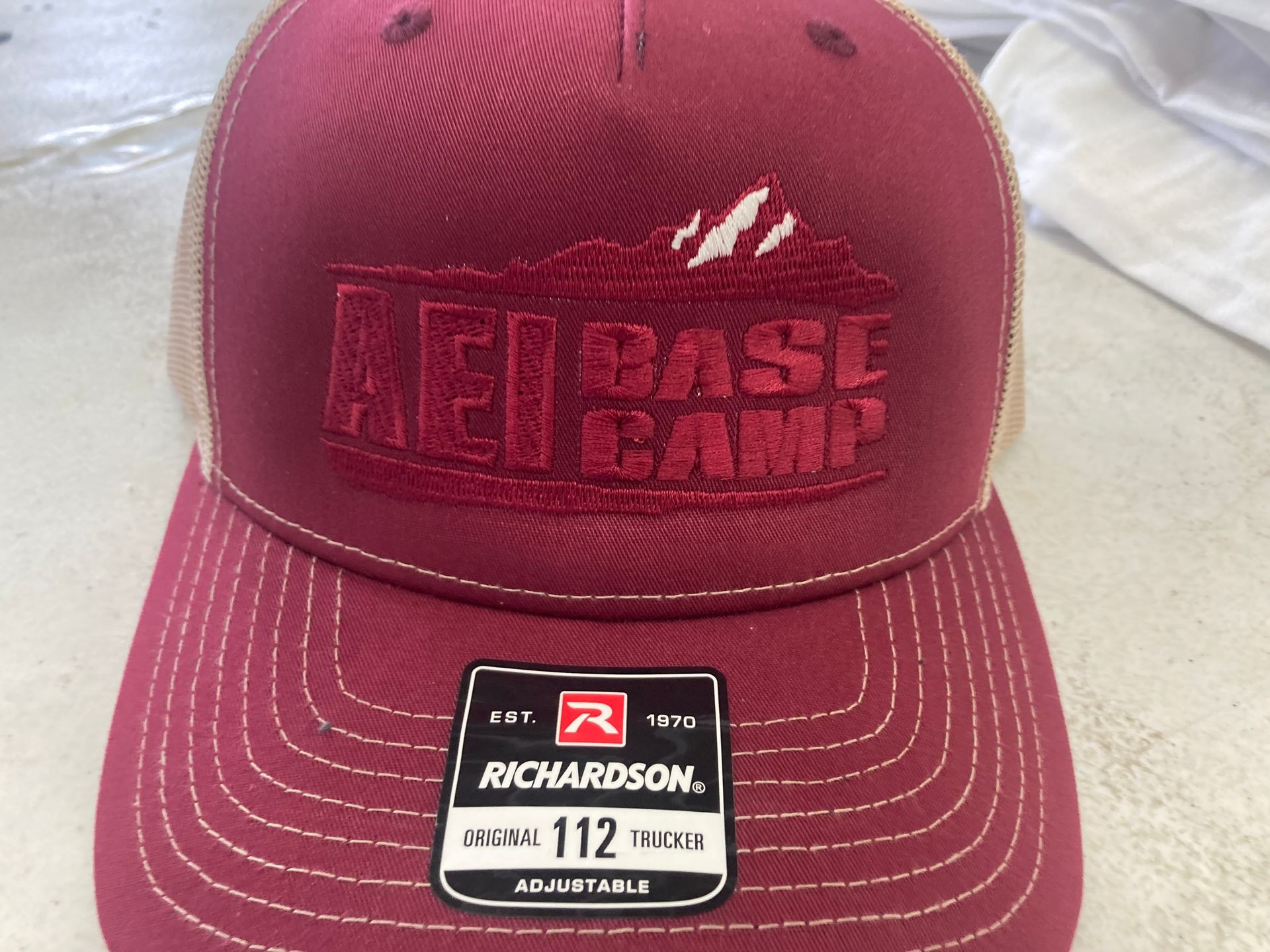 A maroon hat that says richardson on it