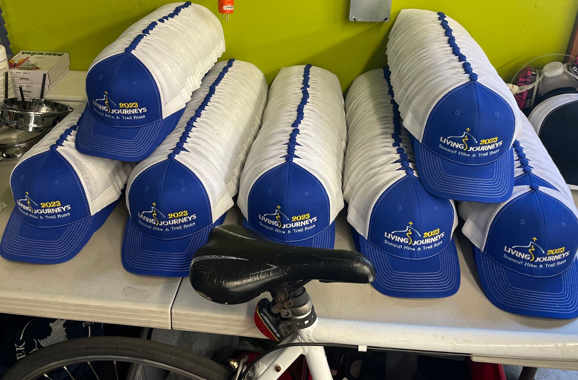 A bunch of blue and white hats are stacked on top of each other