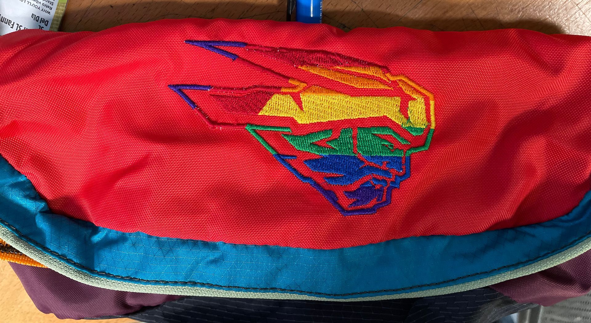 A red and blue purse with a superman logo on it.