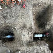 A pipe is coming out of a hole in the ground.