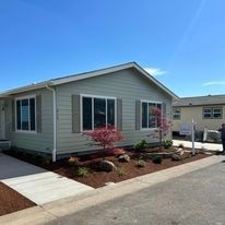 A man is standing in front of a mobile home.