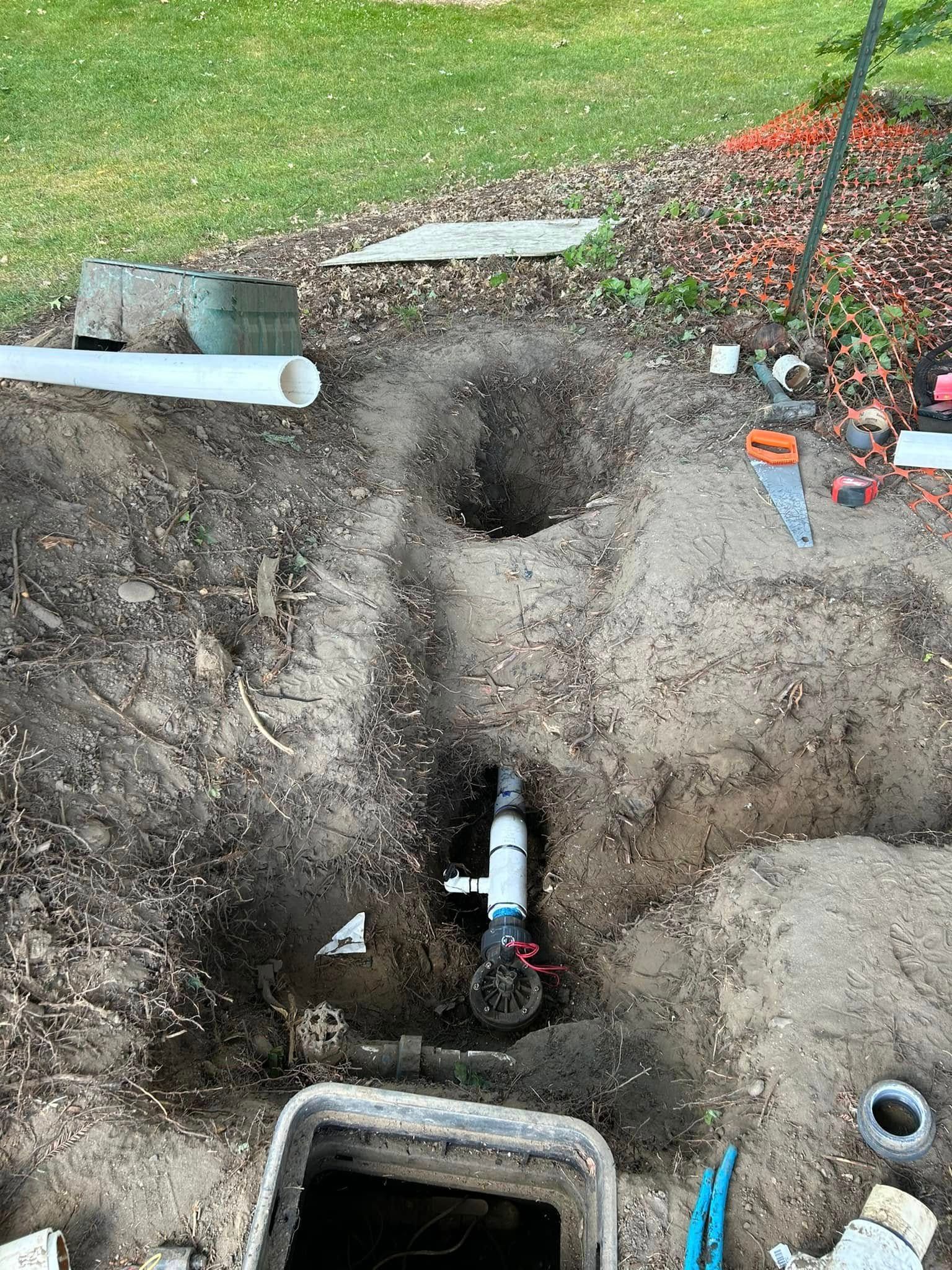 A pipe is being installed in a hole in the ground.
