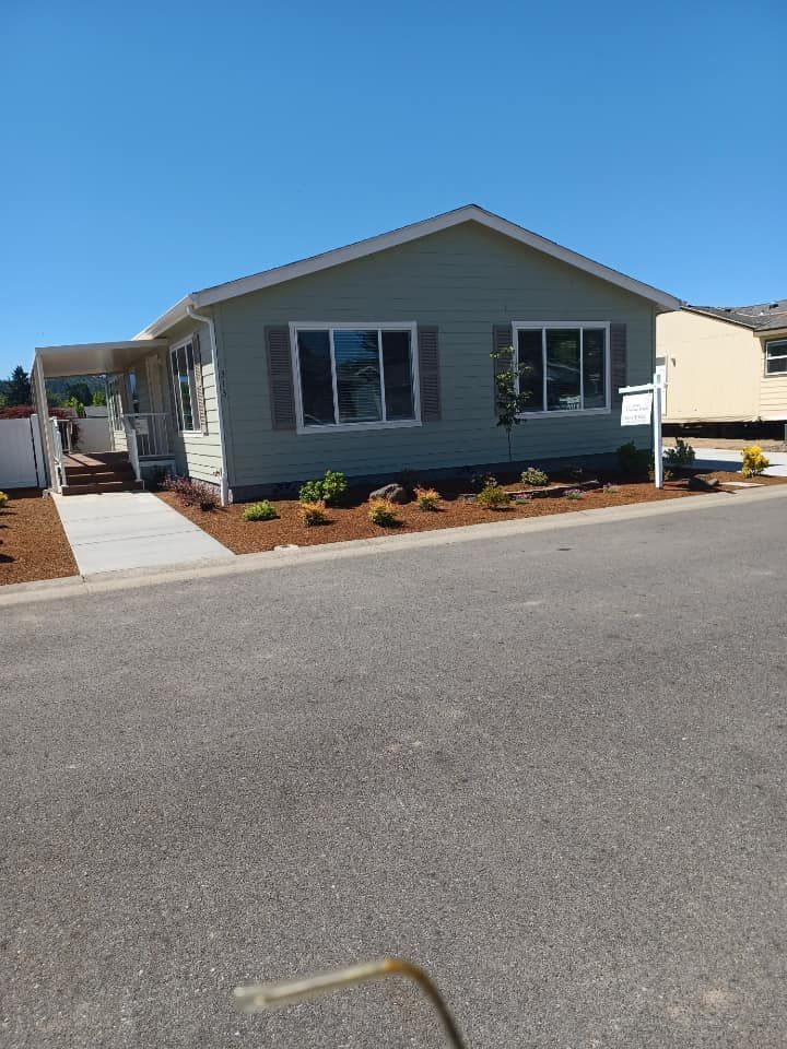 A mobile home is sitting on the side of the road in a residential area.