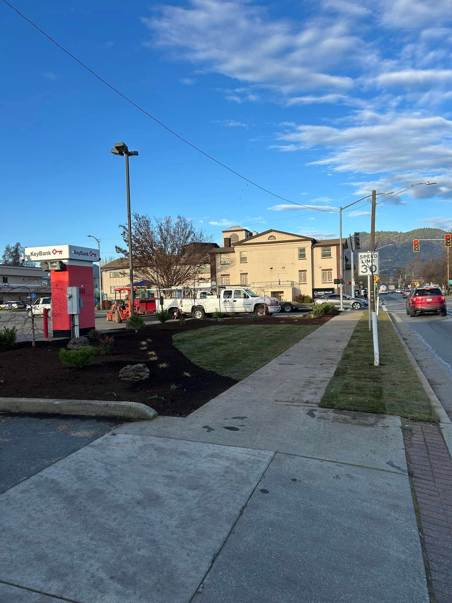 A sidewalk with a telephone booth in the middle of it