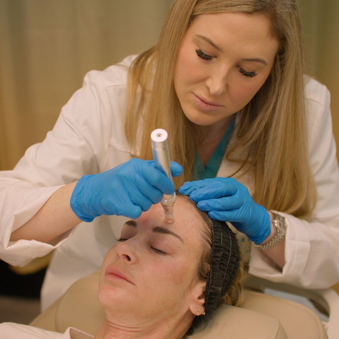 A woman is getting a facial treatment from a doctor.