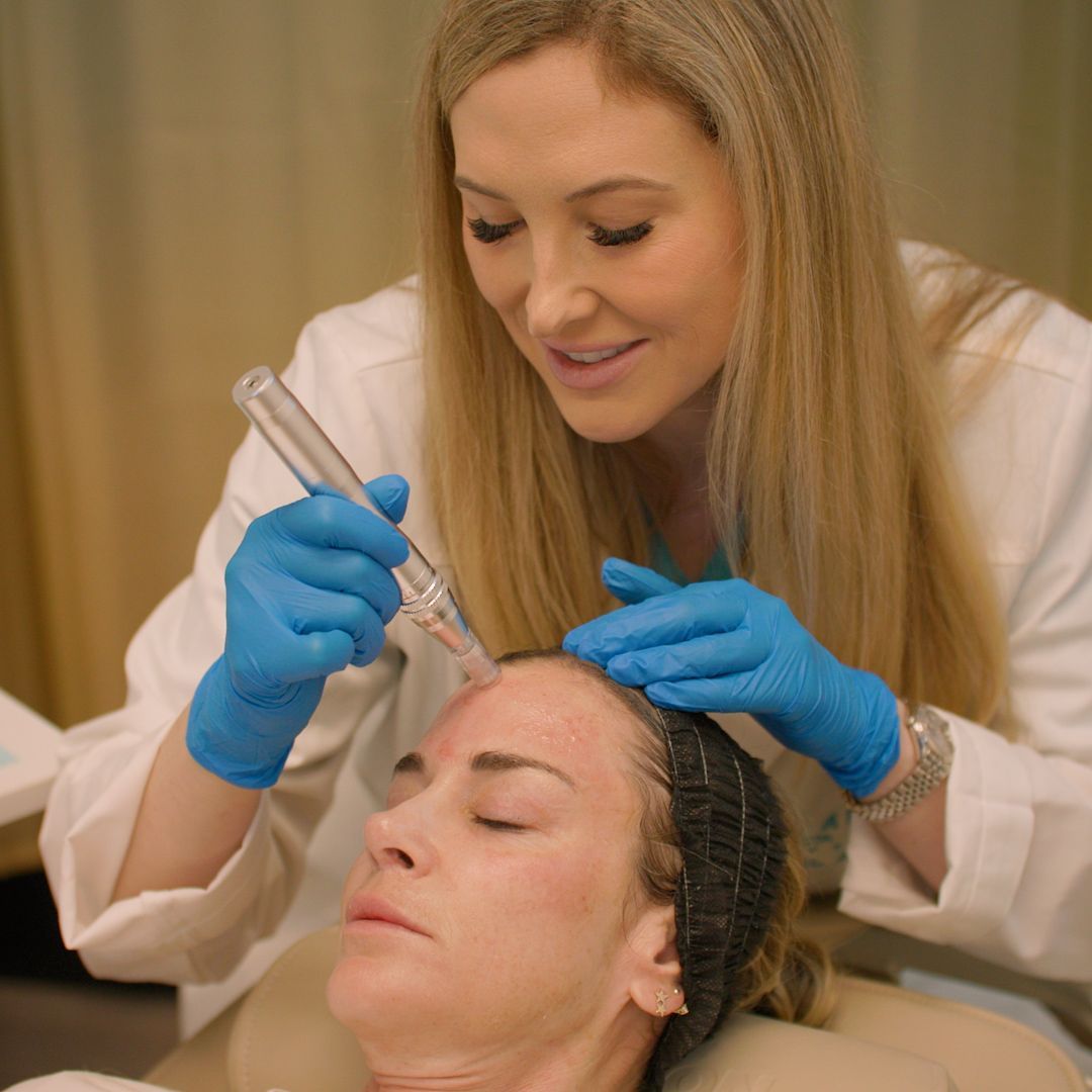 A woman is getting a facial treatment from a doctor.