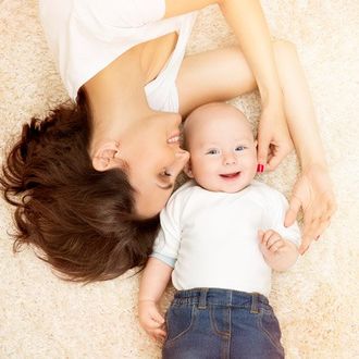 mother and baby on white carpet