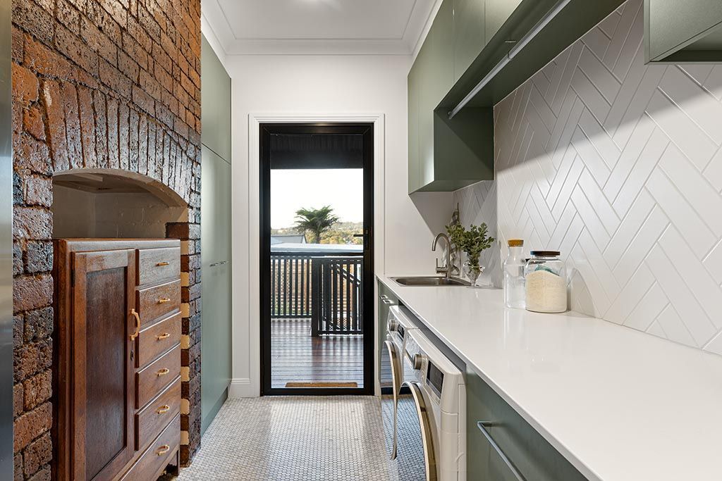 a kitchen with a sliding glass door and a brick wall .