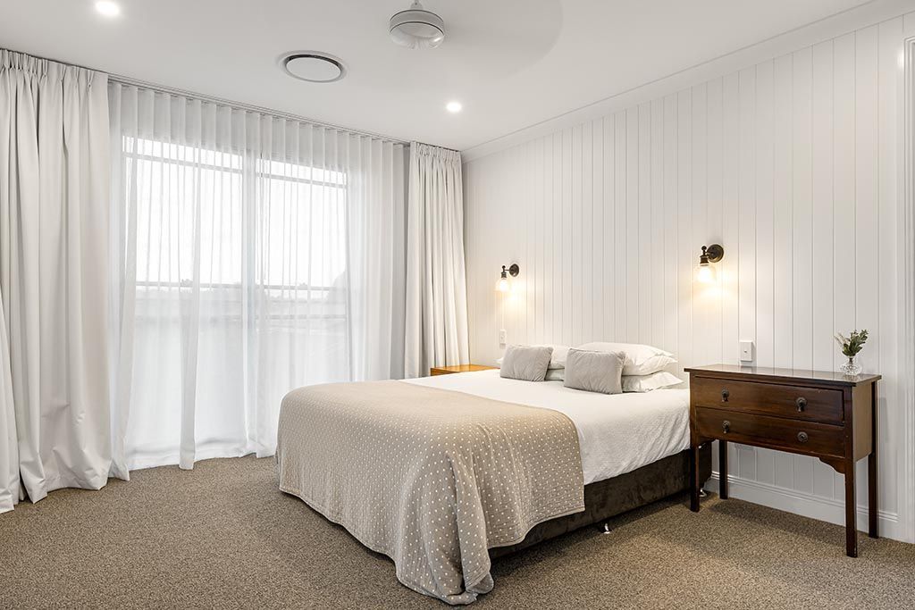 there is a large bed in the middle of the room .