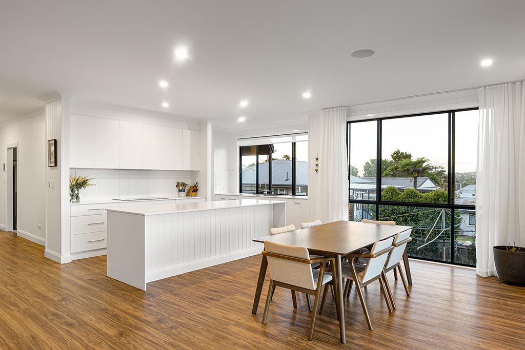 there is a dining table and chairs in the middle of the room .