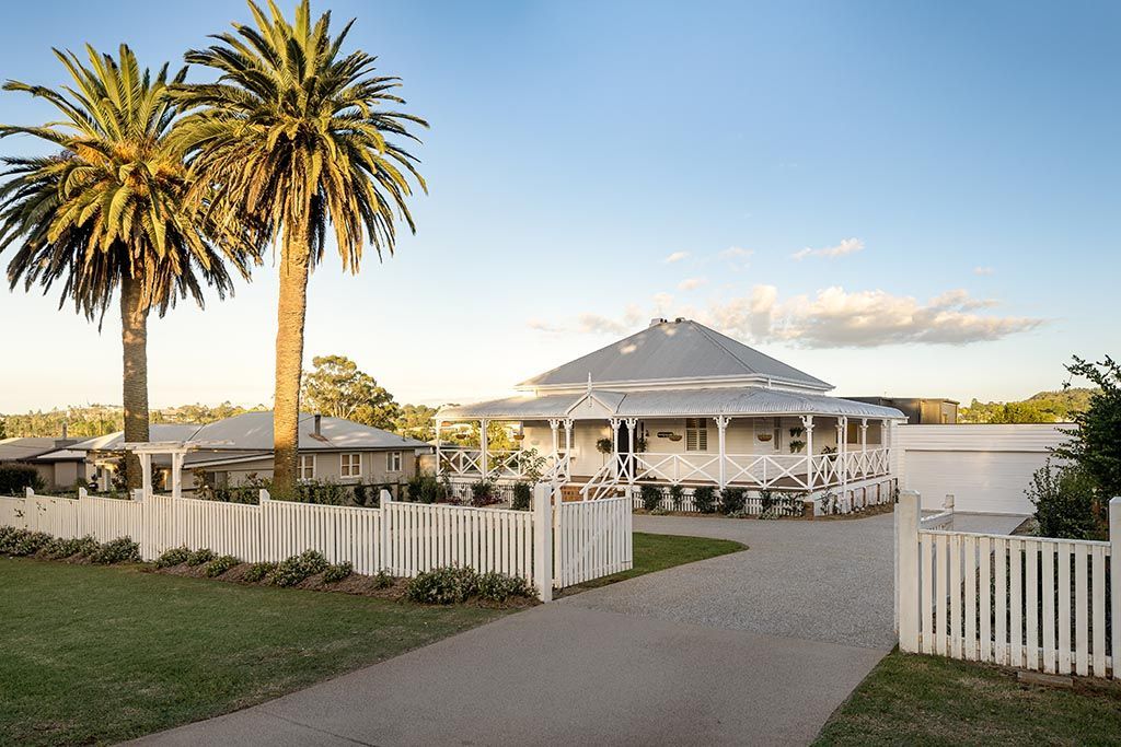 a white house with palm trees in front of it
