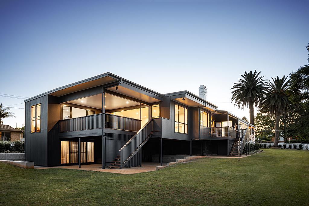 a large house with a lot of windows and stairs