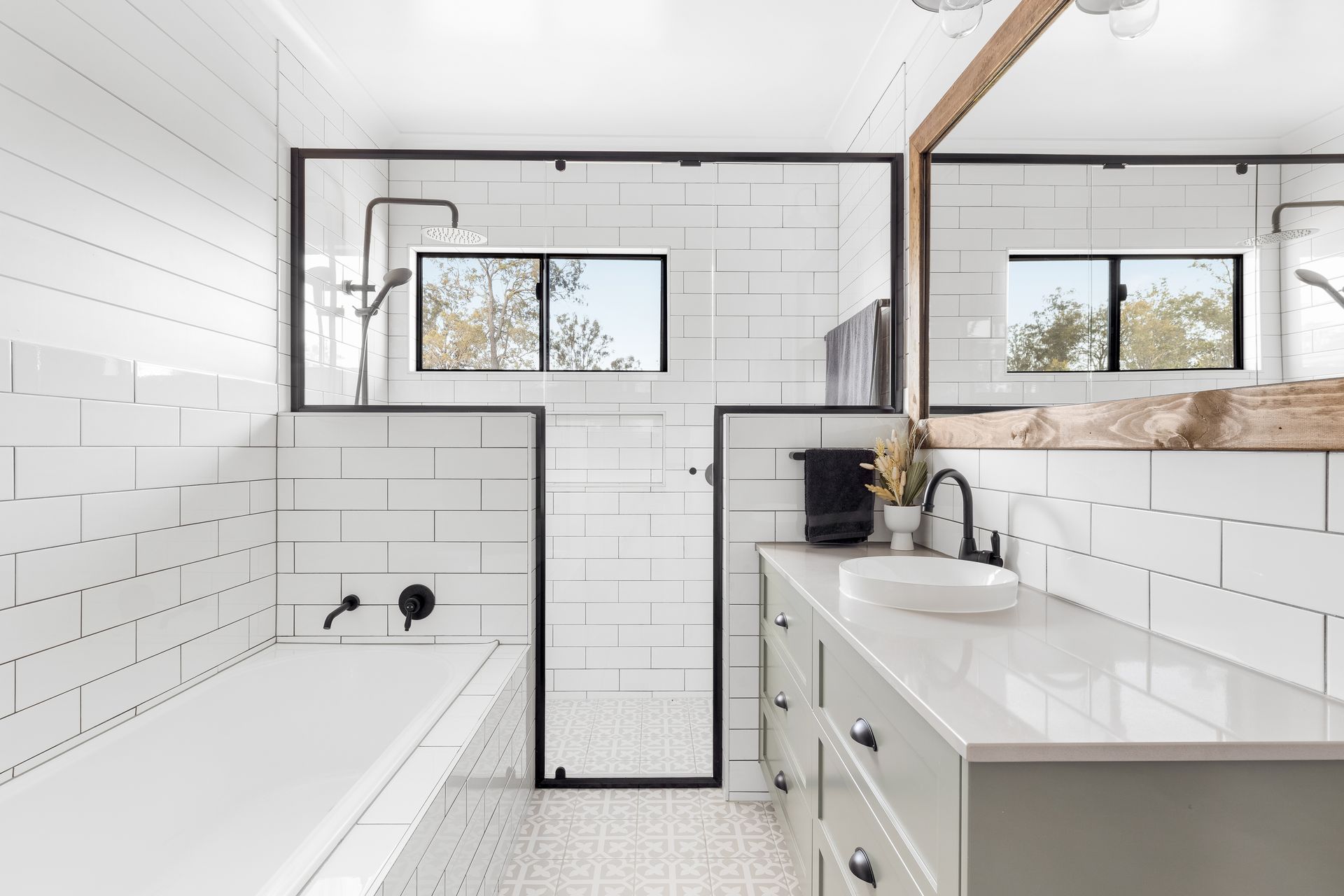 a bathroom with white tiles , a sink , and a bathtub .