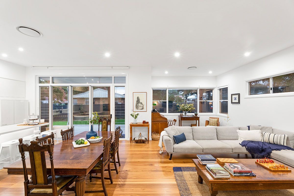 a living room with a couch , table and chairs .
