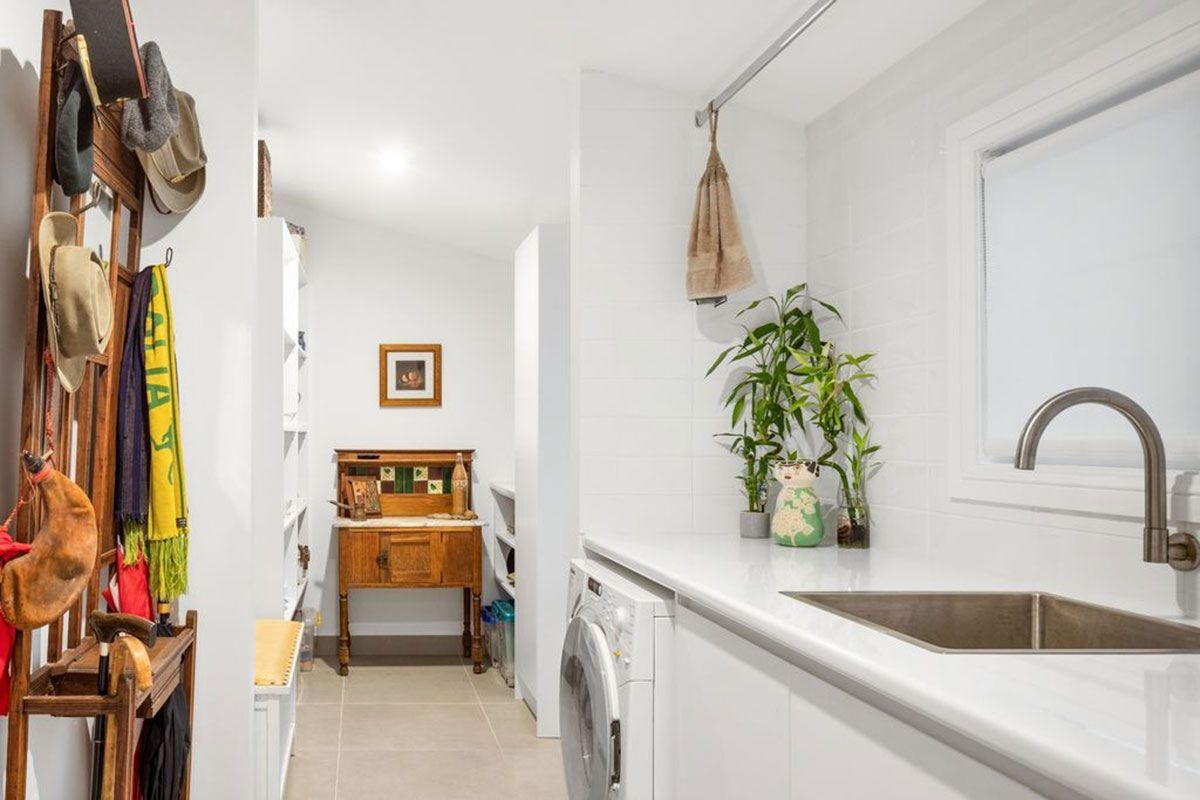 a laundry room with a sink , washer and dryer .