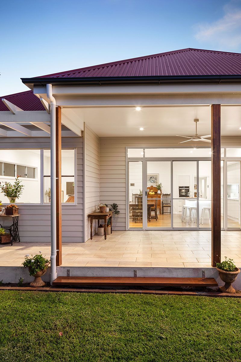 a house with a covered porch and sliding glass doors