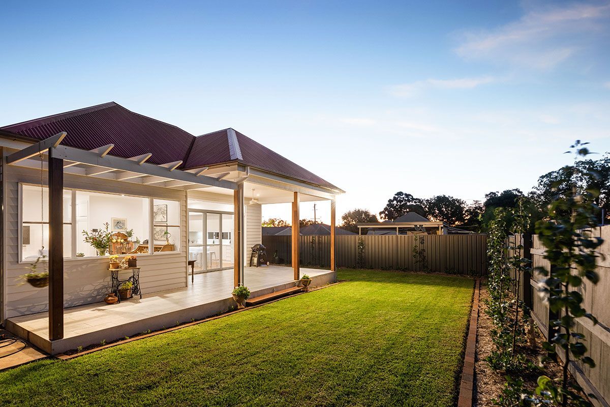 a house with a large lawn in front of it .