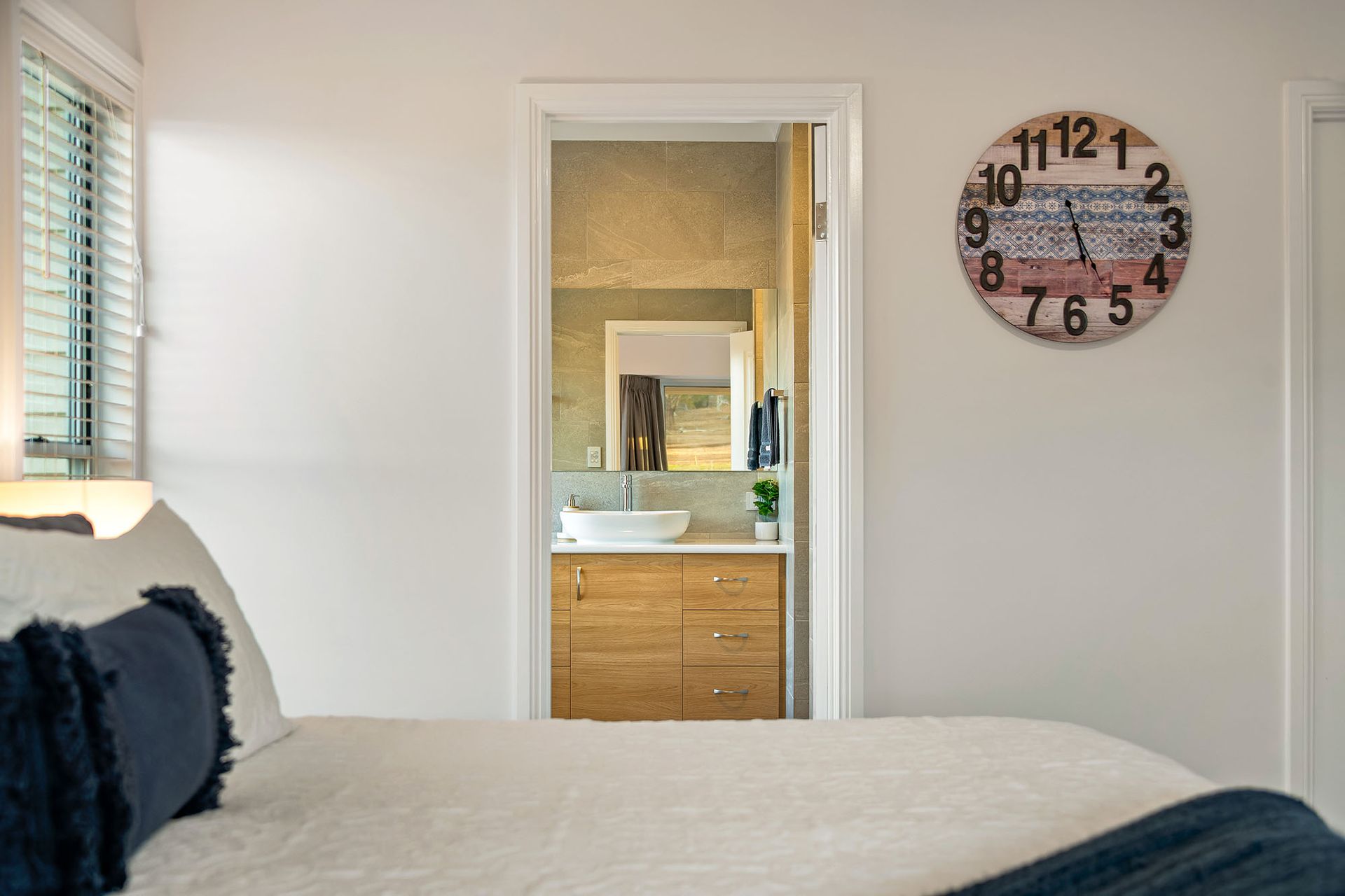 a bedroom with a bed and a clock on the wall .
