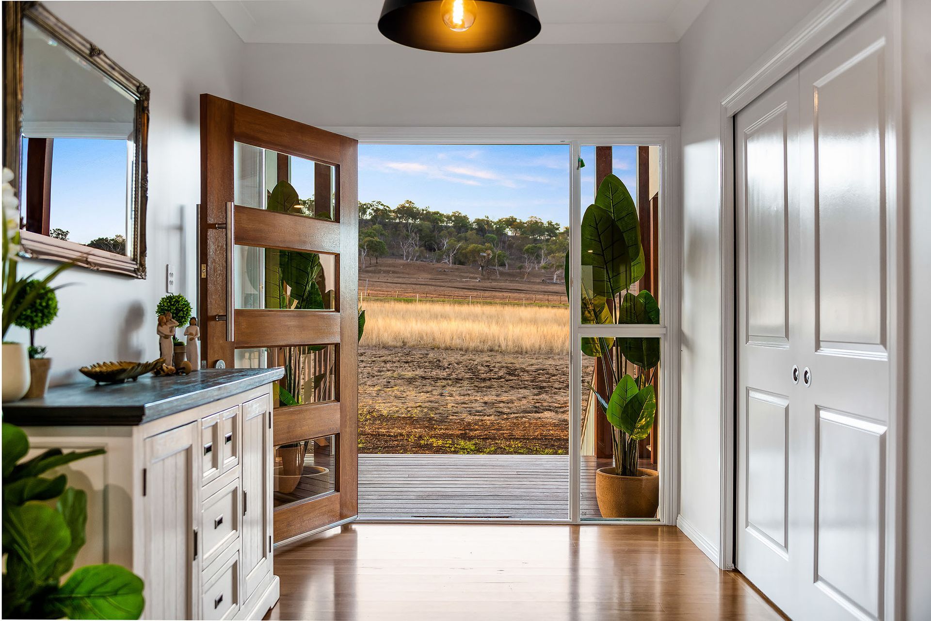 a hallway with a sliding glass door and a view of a field .